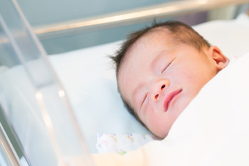 Newborn baby boy sleep at obstetric room in hospital, 1 days of life, Asian baby