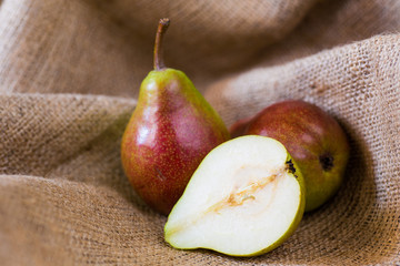 Pears on a wooden background and burlap
