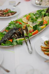 Big fish on table during catering event. Catering buffet.