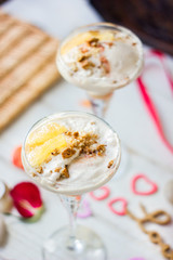Ice cream dessert on table with hearts, ribbons and cloves.