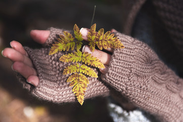 two hands in gloves holding a yellow sheet
