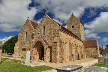 Fototapeta premium St Lawrence Church, Jersey, U.K. Wide angle image of a partly Medieval building and cemetery in the Summer.