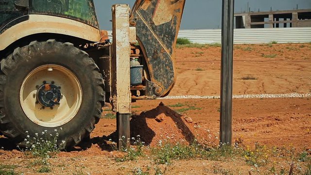 Cinemagraph of tractor with a drilling device at a construction site