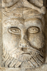 Fototapeta na wymiar Romanesque Carving of a Strange Head or Face (c12th) Capital in Cloisters of Montmajour Abbey near Arles Provence France