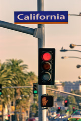 Red traffic light at California Avenue street sign.