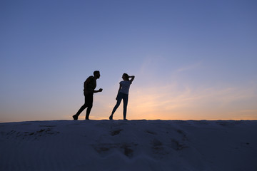 Two lovers of heart, guy and girls are having fun and running th