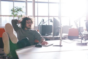 businessman sitting with legs on desk