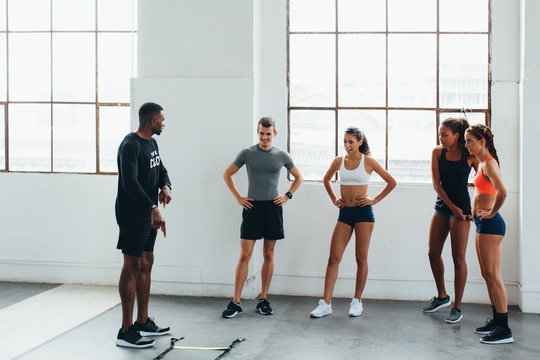 Professional coach teaching a boot camp class to young athletes.