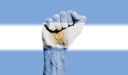 Argentinia flag painted on a clenched fist. Strength, Power, Protest concept