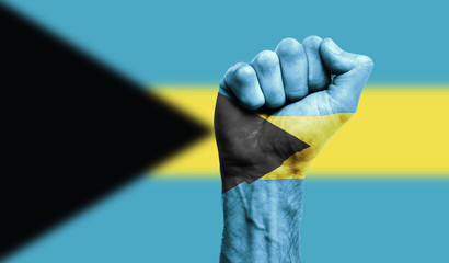 Bahamas flag painted on a clenched fist. Strength, Power, Protest concept