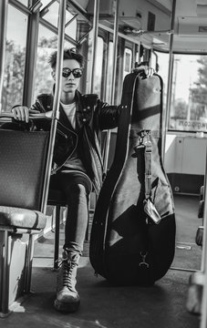 punk rock female muscian in public transport.