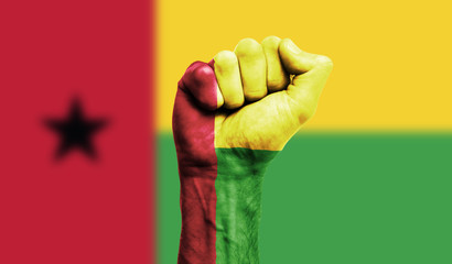 Guinea Bissau flag painted on a clenched fist. Strength, Power, Protest concept