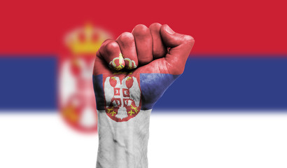 Serbia flag painted on a clenched fist. Strength, Power, Protest concept