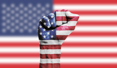 Obraz premium USA flag painted on a clenched fist. Strength, Power, Protest concept