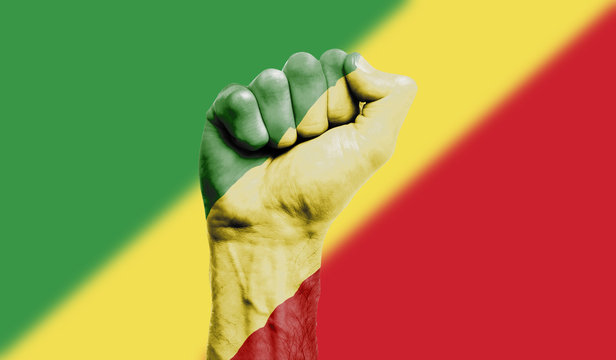 Republic of congo flag painted on a clenched fist. Strength, Power, Protest concept - Powered by Adobe