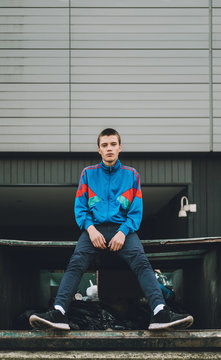 Young adolescents in colorful  track suits from 90's in east Europe projects.