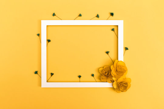 Picture frame with flowers on a yellow background