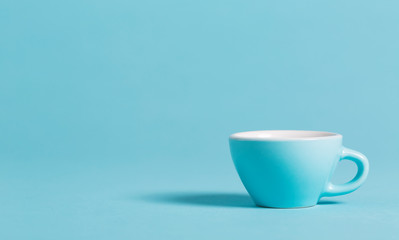 Little blue teacup on a bright background
