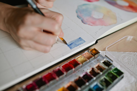 Girl artist paints color chart