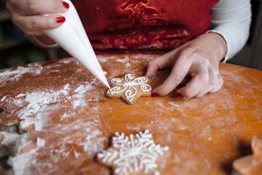 Woman decorating Christmas cookies