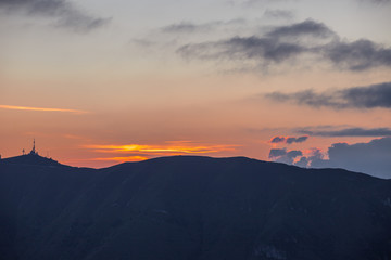 Sunset silhouette with storm in the distance, Cansiglio forest, Veneto, Italy