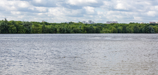 Wide river in the city on a summer day
