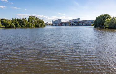 Fototapeta na wymiar Wide river in the city on a summer day 