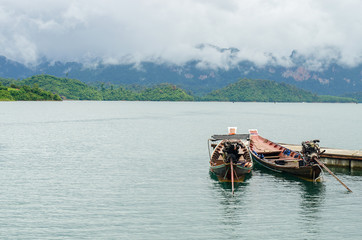 Fototapeta na wymiar Boat on Lake at Ratchaprapa dam, Khaosok National Park, Thailand