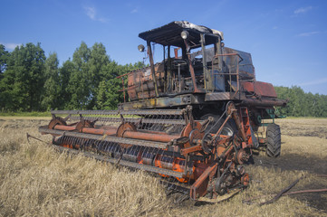 Fototapeta premium Old combine harvester lighted up on harvesting of the grain