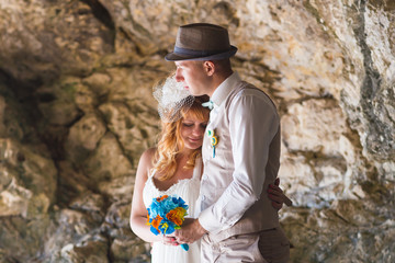 Sensual portrait of a young newlywed couple. Bride and groom outdoor