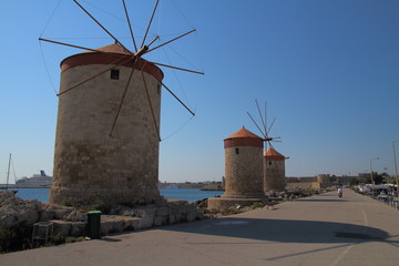 Fototapeta na wymiar Mills in Mandraki harbour in Rhodes, Greece