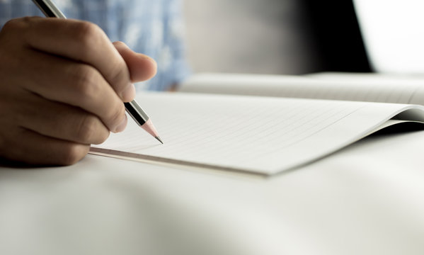 pencil write on notebook