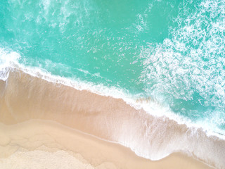 Aerial view of sandy beach and ocean with waves