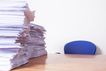 desk with stacked papers, work and stress