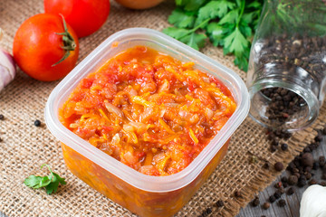 Fried carrots with onions in a container