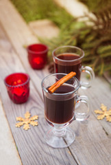 Obraz na płótnie Canvas christmas concept mulled wine hot alcoholic drink with spices garnished autumn leaves space for text