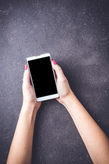 Woman holding white smart phone