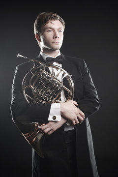 French horn player. Classical musician portrait