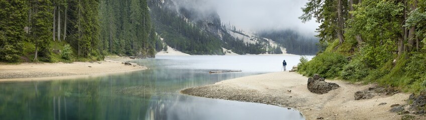 panorama of lake with photographer in Italy