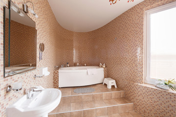Modern luxury bathroom with bathtub and window. Interior design.