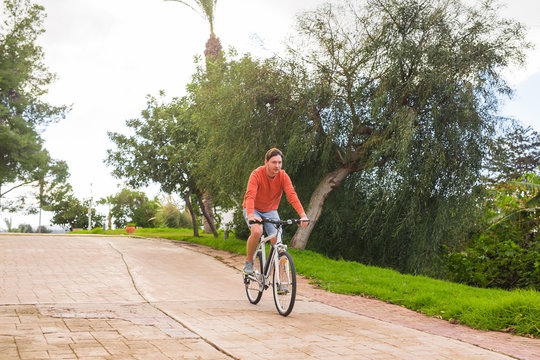 Young man with electric bicycle or E-bike
