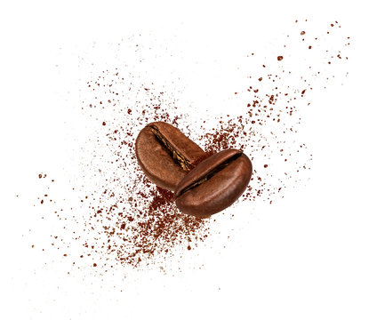 Two coffee beans collide in the air on white background