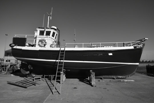 Traditional Fishing Boat Out Of The Water For A Service.