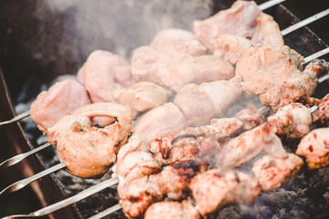 Barbecue roasted pieces of meat on metall skewers