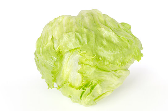 Iceberg lettuce front view on white background. Also crisphead, a fresh light green salad head. Sometimes called cabbage lettuce. Variety of Lactuca sativa. Macro food photo close up.