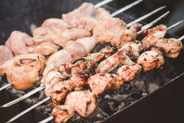 Barbecue roasted pieces of meat on metall skewers