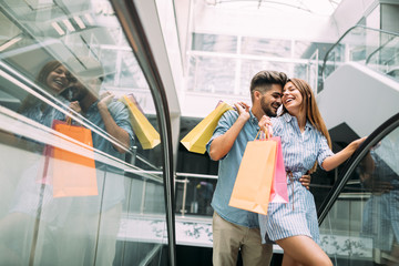 Happy attractive loving couple enjoy shopping together