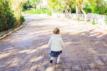 Fototapeta na wymiar Active little girl run