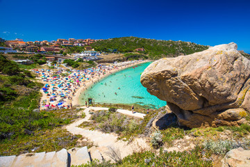 Spiaggia di Rena Bianca beach with red rocks and azure clear water, Costa Smeralda, Sardinia, Italy