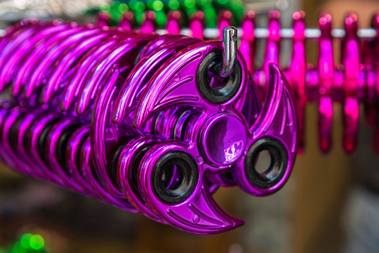 A rack in a toy store with various spinners.